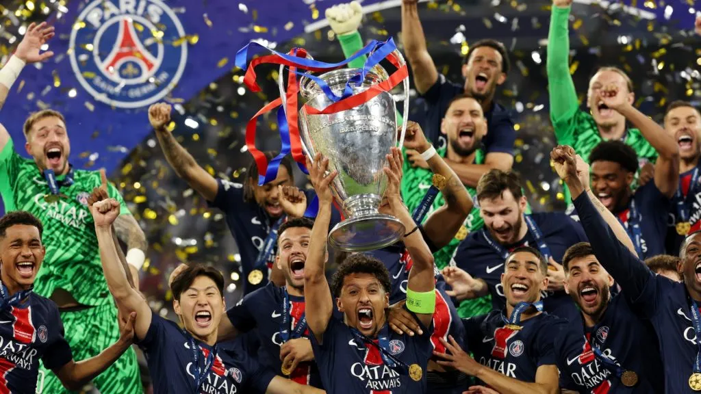 Marquinhos of Paris Saint-Germain lifts the UEFA Champions League trophy after his team's victory, to secure Paris Saint-Germain's first ever UEFA Champions League title in the club's history and a record UEFA Champions League Final winning scoreline of 5-0, following the UEFA Champions League Final 2025 between Paris Saint-Germain and FC Internazionale Milano at Munich Football Arena on May 31, 2025 in Munich, Germany.