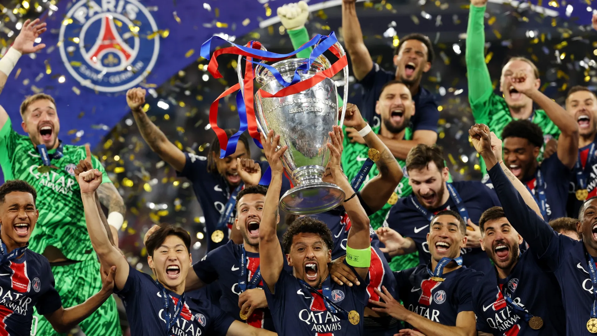 Marquinhos of Paris Saint-Germain lifts the UEFA Champions League trophy after his team's victory, to secure Paris Saint-Germain's first ever UEFA Champions League title in the club's history and a record UEFA Champions League Final winning scoreline of 5-0, following the UEFA Champions League Final 2025 between Paris Saint-Germain and FC Internazionale Milano at Munich Football Arena on May 31, 2025 in Munich, Germany.