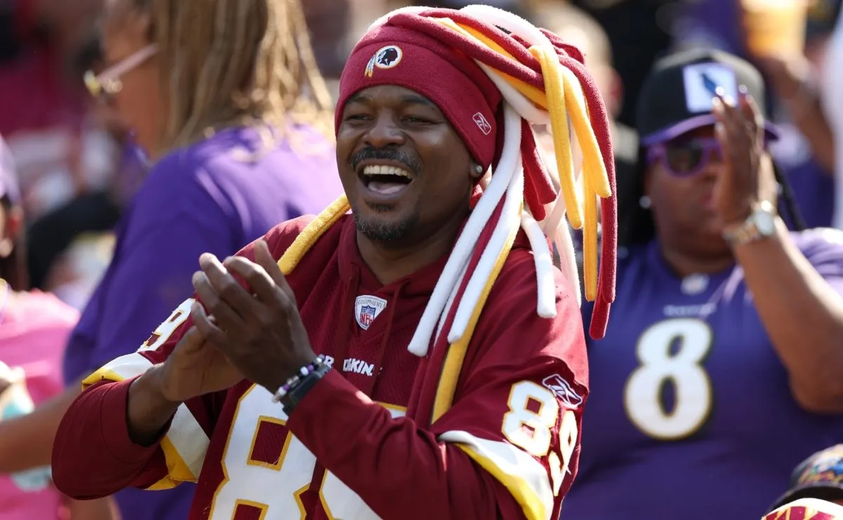 A Washington Commanders fan cheers during a game against the Baltimore Ravens in 2024. (Source: Rob Carr/Getty Images)