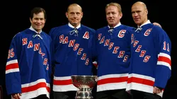 Adam Graves poses with former New York Rangers players Mike Richter, Brian Leetch and Mark Messier after Graves' jersey was raised to the rafters of the Madison Square Garden arena during a ceremony prior to a game in 2008.