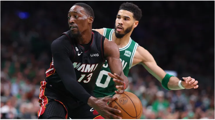Bam Adebayo #13 of the Miami Heat controls the ball ahead of Jayson Tatum #0 of the Boston Celtics