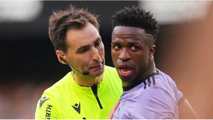 Referee Ricardo de Burgos Bengoetxea speaks with Vinicius Junior of Real Madrid during the LaLiga Santander match between Valencia CF and Real Madrid CF at Estadio Mestalla on May 21, 2023 in Valencia, Spain.