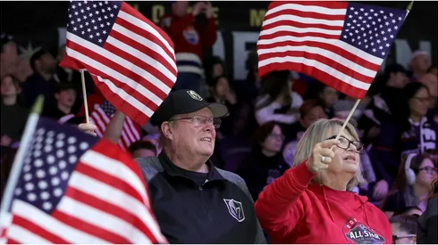 Fans wave American flags as they celebrate