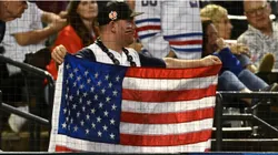 A fan of the United States holds up a flag