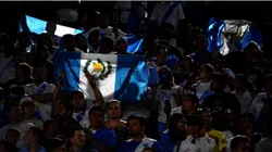 Guatemala fans hold up flags before the match