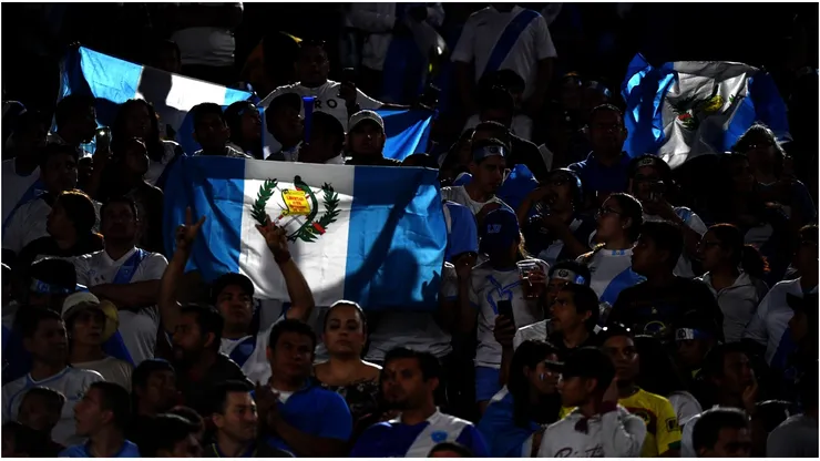 Guatemala fans hold up flags before the match