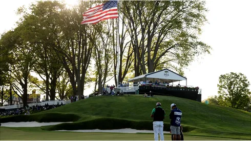 Hideki Matsuyama of Japan and caddie Shota Hayafuji wait on a fairway during the first round of the 2023 PGA Championship