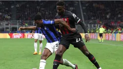 Denzel Dumfries of FC Internazionale is challenged by Divock Origi of AC Milan