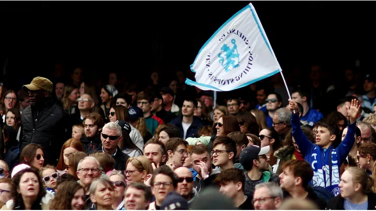 Chelsea fans wave flags in support of their team during the UEFA Women's Champions League semifinal 1st leg match between Chelsea FC and FC Barcelona at Stamford Bridge on April 22, 2023 in London, England.