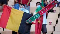 Fans of Belgium and Portugal wave a flag and a scarf