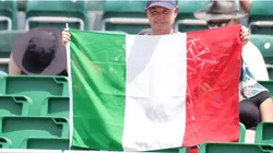 A fan holds an Italian flag