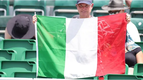 A fan holds an Italian flag