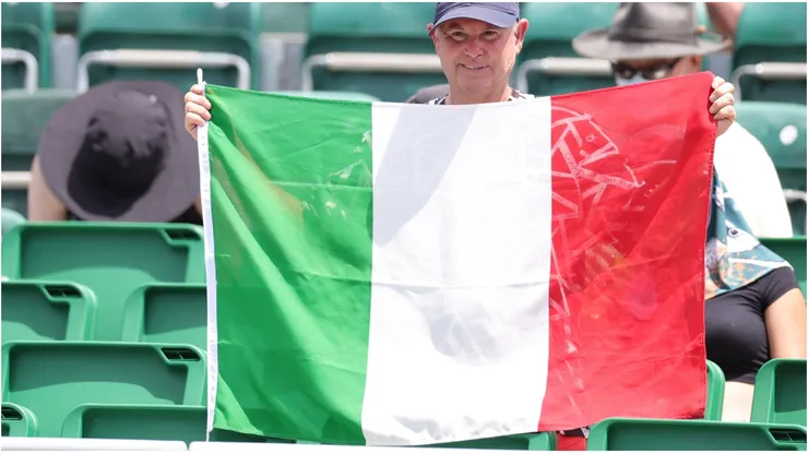A fan holds an Italian flag