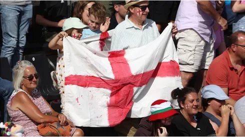 Fans hold a large English flag
