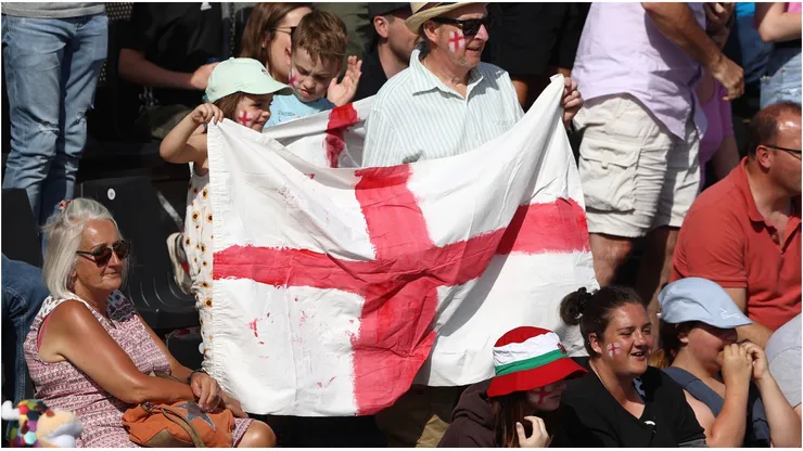 Fans hold a large English flag