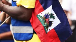 A man holds a Haitian flag