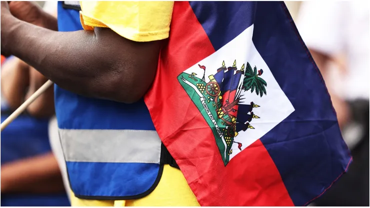 A man holds a Haitian flag