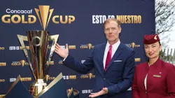 Former U.S. player Alexi Lalas poses with the Gold Cup trophy
