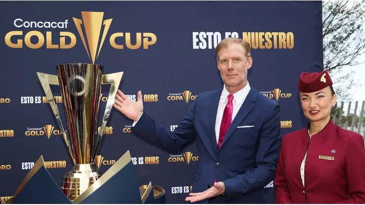Former U.S. player Alexi Lalas poses with the Gold Cup trophy