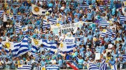 Uruguay fans hold up their country's flags