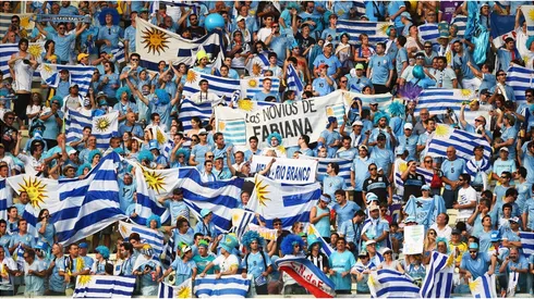 Uruguay fans hold up their country's flags