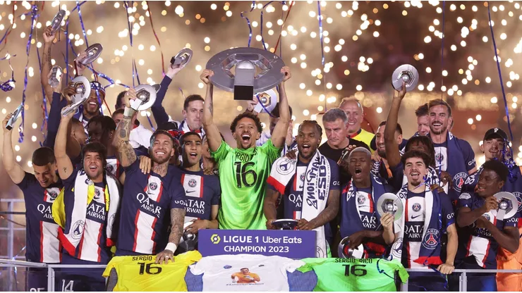 Marquinhos of Paris Saint-Germain, wearing a match shirt featuring the name of Sergio Rico and number 16, lifts the Ligue 1 Uber Eats trophy after the Ligue 1 match between Paris Saint-Germain and Clermont Foot at Parc des Princes on June 03, 2023 in Paris, France.