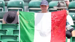 A fan holds an Italian flag