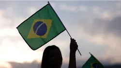 Fans wave a Brazil flag outside the stadium