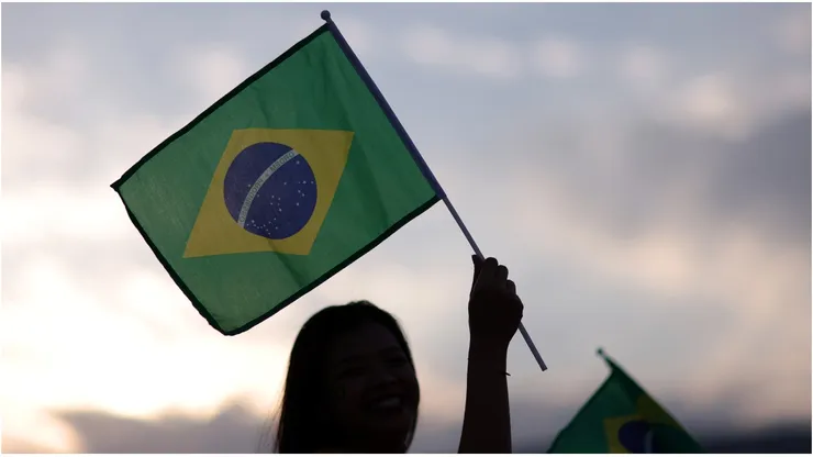 Fans wave a Brazil flag outside the stadium