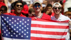 Fans hold an American flag