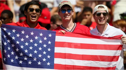 Fans hold an American flag