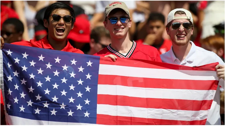 Fans hold an American flag