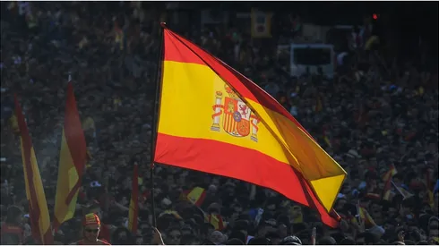 A Spain supporter flies the national flag