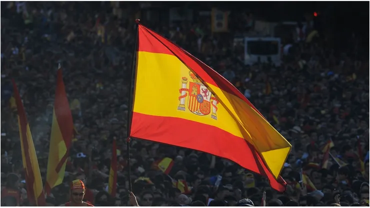 A Spain supporter flies the national flag