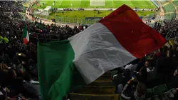 A general view inside the stadium as a fan waves the flag of Italy