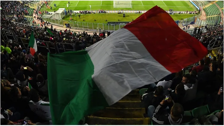 A general view inside the stadium as a fan waves the flag of Italy