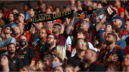 Fans stand prior to the match