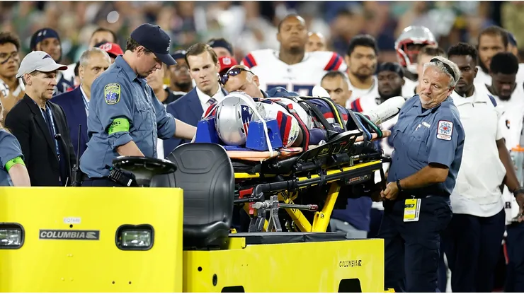 Isaiah Bolden of the Patriots attended by medical staff at Lambeau Field