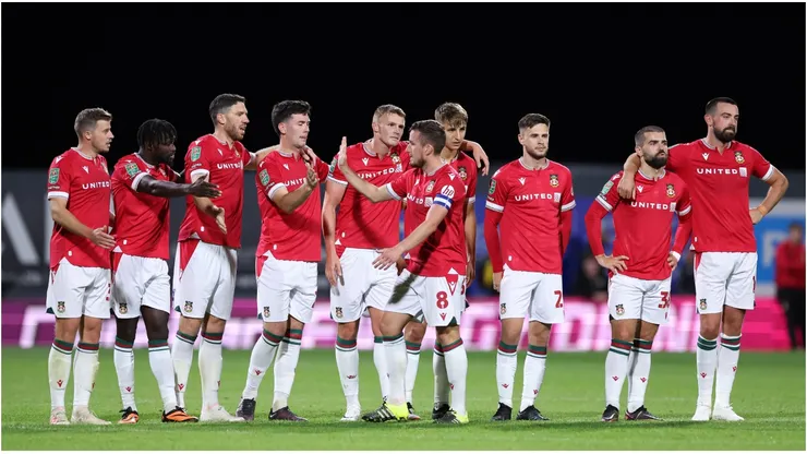 Luke Young of Wrexham celebrates with team mates