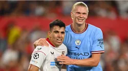 Marcos Acuna of Sevilla FC reacts with Erling Haaland of Manchester City