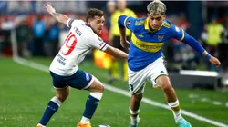 Alfonso Trezza of Nacional competes for the ball with Exequiel Zeballos of Boca Juniors