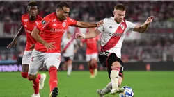 Lucas Beltrán of River Plate competes for the ball with Gabriel Mercado of Internacional