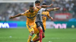 Maximiliano Meza of Monterrey fights for the ball with Rafael De Souza of Tigres