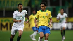 Marquinhos of Brazil fights for the ball with Bruno Miranda of Bolivia