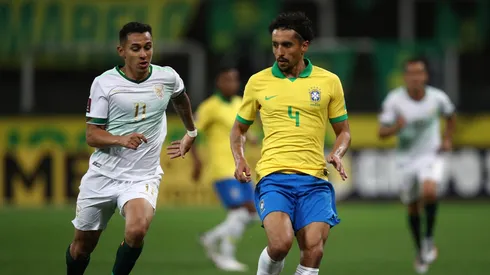 Marquinhos of Brazil fights for the ball with Bruno Miranda of Bolivia