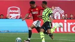 Jadon Sancho #25 of Manchester United scores as Gabriel Magalhaes #6 of Arsenal
