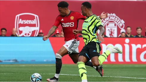 Jadon Sancho #25 of Manchester United scores as Gabriel Magalhaes #6 of Arsenal