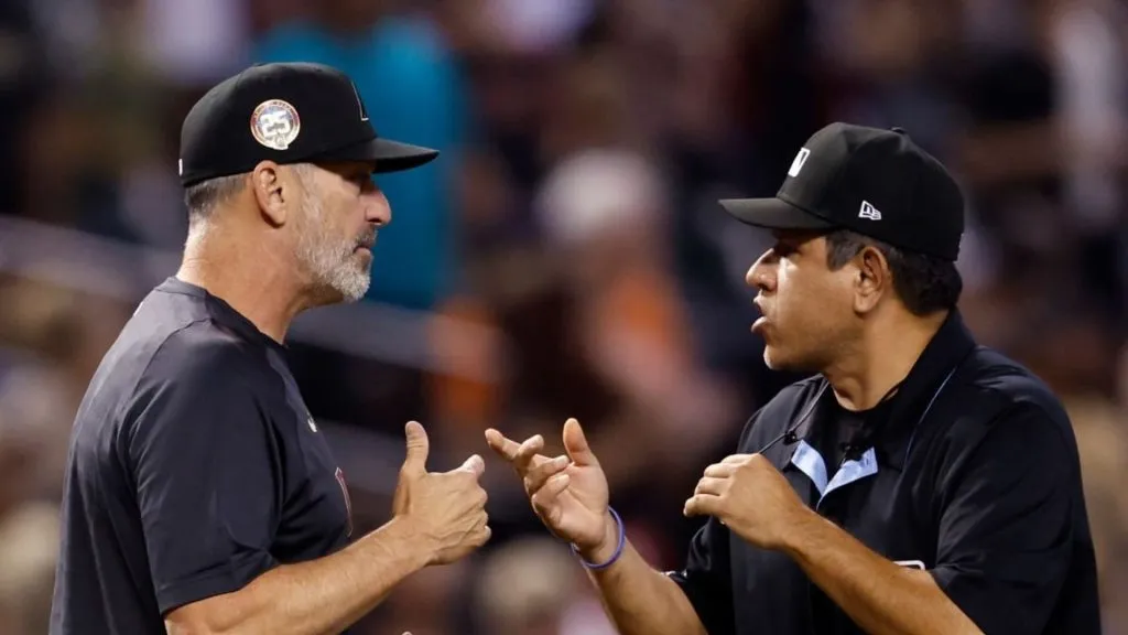 Manager Torey Lovullo #17 of the Arizona Diamondbacks challenges a call on Dominic Fletcher's home run with umpire Alfonso Marquez