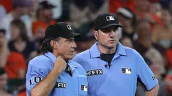 Umpires Phil Cuzzi and Dan Bellino await the review of a play