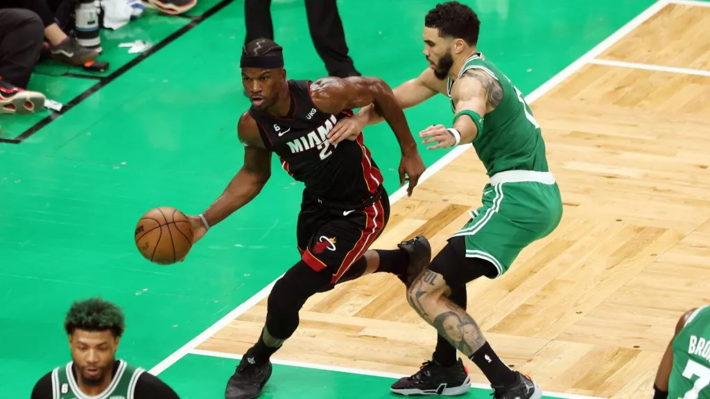 Jimmy Butler #22 of the Miami Heat dribbles against Jayson Tatum #0 of the Boston Celtics